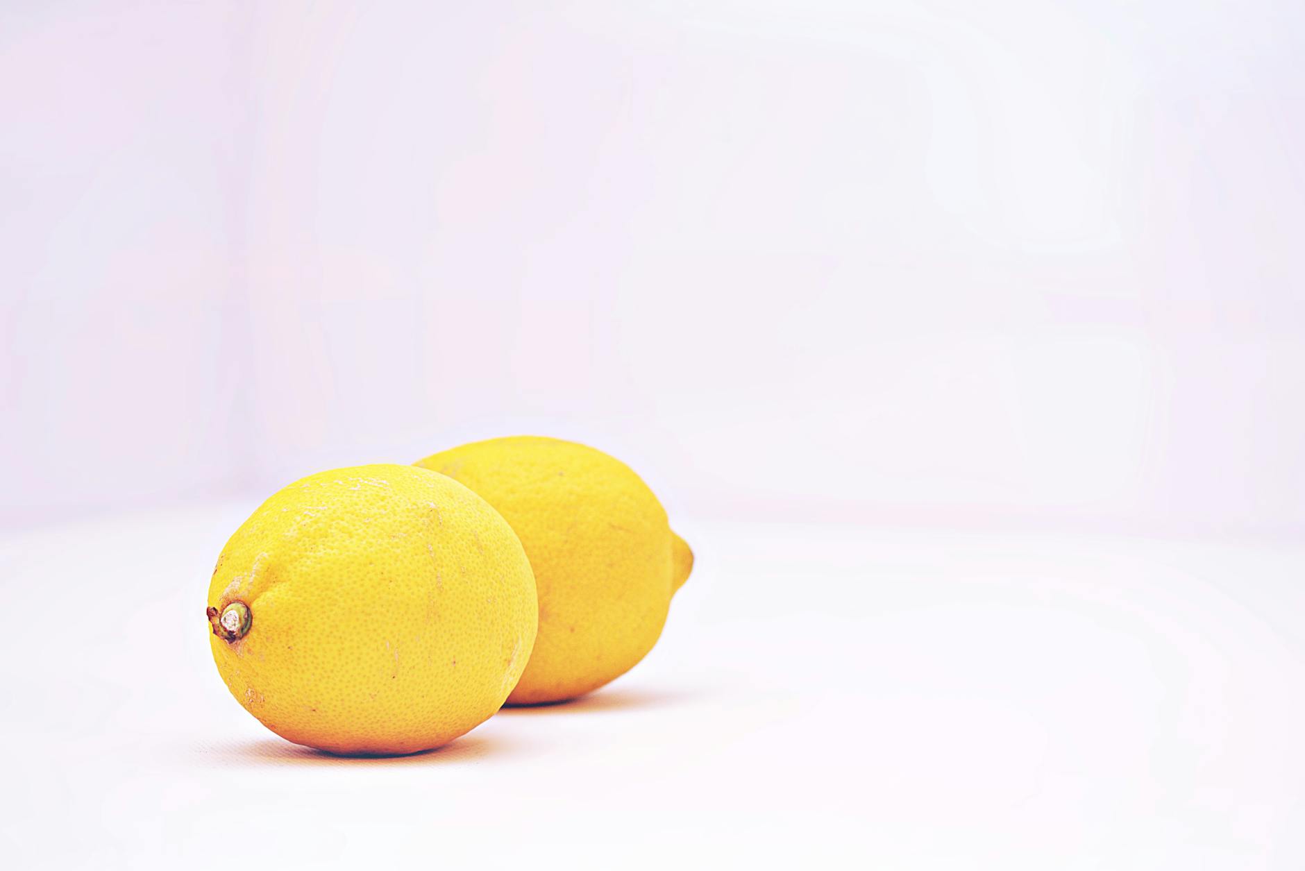 Two vibrant lemons on a white background, symbolizing cycle phases and sensitivity shifts