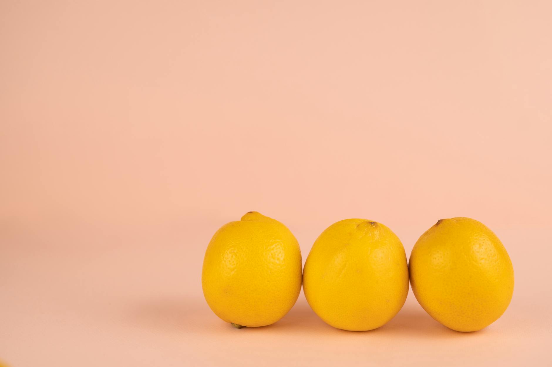 Bright, ripe lemons on a soft pastel background symbolizing vitality and sensual pleasure